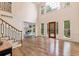Bright living room featuring hardwood floors, large windows, and a staircase leading to the upper level at 2655 Boulder Creek Ne Dr, Roswell, GA 30075
