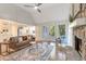Open-concept living room featuring a stone fireplace, cathedral ceilings, hardwood floors, and abundant natural light at 2655 Boulder Creek Ne Dr, Roswell, GA 30075