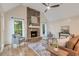 Vaulted living room with a stone fireplace, large windows, hardwood floors, and comfortable seating arrangement at 2655 Boulder Creek Ne Dr, Roswell, GA 30075