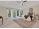 Spacious main bedroom with a tray ceiling, balcony access, and seating area filled with natural light at 2655 Boulder Creek Ne Dr, Roswell, GA 30075