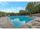 Large swimming pool with diving board and several patio sets with umbrellas that are set up for residents at 2655 Boulder Creek Ne Dr, Roswell, GA 30075