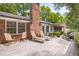 Spacious back deck with lounge chairs, outdoor seating, and brick chimney at 3792 Harts Mill Ne Ln, Brookhaven, GA 30319