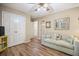 Bedroom with hardwood floors, neutral walls, and modern sofa at 3792 Harts Mill Ne Ln, Brookhaven, GA 30319