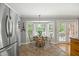 Bright breakfast nook with bay window and elegant light fixture with seating for four at 3792 Harts Mill Ne Ln, Brookhaven, GA 30319
