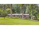 Traditional-style home with lush lawn and mature trees offers a serene, park-like setting at 3792 Harts Mill Ne Ln, Brookhaven, GA 30319