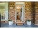 Welcoming front entrance featuring a white door, planters, and charming exterior brickwork at 3792 Harts Mill Ne Ln, Brookhaven, GA 30319