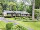 Charming brick home featuring manicured landscaping and a welcoming front yard with mature trees at 3792 Harts Mill Ne Ln, Brookhaven, GA 30319