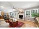 Open living room with hardwood floors, fireplace, and natural light at 3792 Harts Mill Ne Ln, Brookhaven, GA 30319