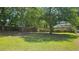Spacious backyard featuring a well-maintained lawn, mature trees, and a privacy fence at 4052 Keheley Glen Ne Dr, Marietta, GA 30066