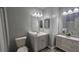 Updated bathroom features modern vanity, sink, mirrors, and updated light fixtures at 4052 Keheley Glen Ne Dr, Marietta, GA 30066