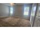 Spacious bedroom with neutral paint, carpeted flooring, and two windows offering natural light at 4052 Keheley Glen Ne Dr, Marietta, GA 30066