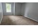 Bedroom features neutral paint, carpeted flooring, and a window allowing natural light at 4052 Keheley Glen Ne Dr, Marietta, GA 30066