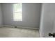 Well-lit bedroom features carpeted floors, neutral paint, and a window for natural light at 4052 Keheley Glen Ne Dr, Marietta, GA 30066