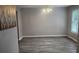 Light-filled dining room with modern chandelier and new vinyl floors at 4052 Keheley Glen Ne Dr, Marietta, GA 30066
