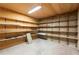 Unfinished basement with built-in shelving offers ample storage and organization options at 5150 Shadow Path Sw Ln, Lilburn, GA 30047