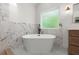 Modern bathroom features a luxurious soaking tub and a stylish vanity with modern fixtures at 5150 Shadow Path Sw Ln, Lilburn, GA 30047