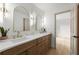 Bathroom featuring dual vanities, quartz countertops, modern lighting, and a doorway to the bedroom at 5150 Shadow Path Sw Ln, Lilburn, GA 30047
