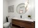 Stylish powder room with modern lighting fixture, floating vanity, and decorative wall art at 5150 Shadow Path Sw Ln, Lilburn, GA 30047