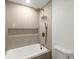 Stylish bathroom featuring a soaking tub, rain shower head, and sleek tile work at 5150 Shadow Path Sw Ln, Lilburn, GA 30047