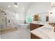 Modern bathroom featuring a marble-tiled shower, soaking tub, and double sink vanity with quartz countertops at 5150 Shadow Path Sw Ln, Lilburn, GA 30047