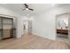 Bright bedroom with light wood floors, ceiling fan, ensuite bathroom, and closet with built-ins at 5150 Shadow Path Sw Ln, Lilburn, GA 30047