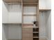 Walk-in closet with built-in shelves, drawers, and ample storage space at 5150 Shadow Path Sw Ln, Lilburn, GA 30047