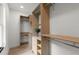 Modern walk-in closet with custom built-in shelving and hanging rods at 5150 Shadow Path Sw Ln, Lilburn, GA 30047