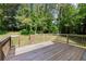 Inviting wooden deck offering an ideal space for outdoor dining and relaxation in a serene setting at 5150 Shadow Path Sw Ln, Lilburn, GA 30047