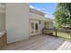 View of a spacious wooden deck, adjacent to the home with convenient access to the backyard at 5150 Shadow Path Sw Ln, Lilburn, GA 30047