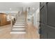 Bright foyer features hardwood floors, modern staircase, and an open view into the spacious kitchen at 5150 Shadow Path Sw Ln, Lilburn, GA 30047