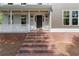 Charming front entrance with brick steps, stylish lighting fixtures, and a welcoming door at 5150 Shadow Path Sw Ln, Lilburn, GA 30047