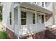 Inviting front porch with white railings, brick steps, and stylish outdoor lighting fixtures at 5150 Shadow Path Sw Ln, Lilburn, GA 30047