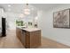 Bright open-concept kitchen with stainless steel appliances, kitchen island, and adjacent seating at 5150 Shadow Path Sw Ln, Lilburn, GA 30047