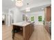 Kitchen with an island featuring seating and stainless steel appliances, open floor plan at 5150 Shadow Path Sw Ln, Lilburn, GA 30047