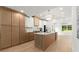 Modern kitchen with white cabinets, marble countertops, island, and stainless steel appliances at 5150 Shadow Path Sw Ln, Lilburn, GA 30047