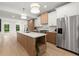 Stylish kitchen with island, stainless steel appliances, and abundant cabinet space at 5150 Shadow Path Sw Ln, Lilburn, GA 30047