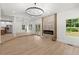 Open-concept living space with modern fireplace, recessed lighting, and beautiful hardwood floors at 5150 Shadow Path Sw Ln, Lilburn, GA 30047