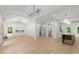 Bright and airy living room featuring modern chandeliers, recessed lights, and open floor plan at 5150 Shadow Path Sw Ln, Lilburn, GA 30047