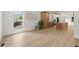 Bright open-concept living space with light wood floors and large windows at 5150 Shadow Path Sw Ln, Lilburn, GA 30047