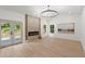 Spacious living room featuring a modern fireplace, recessed lights, light hardwood floors and french doors at 5150 Shadow Path Sw Ln, Lilburn, GA 30047