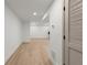 A room with light wood flooring and a door with slats on the right side of the picture at 5150 Shadow Path Sw Ln, Lilburn, GA 30047