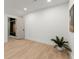 A room with light wood flooring, a potted plant and open doors to more rooms at 5150 Shadow Path Sw Ln, Lilburn, GA 30047