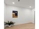 A room with light wood flooring, a potted plant and a picture on the wall at 5150 Shadow Path Sw Ln, Lilburn, GA 30047