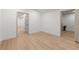 A room with light wood flooring and doorways that lead to other rooms at 5150 Shadow Path Sw Ln, Lilburn, GA 30047