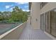 Relaxing private balcony, light gray wood, with views of mature trees and community tennis court at 683 Highland Ct, Marietta, GA 30068