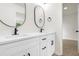 Bathroom with dual sinks, black hardware, modern lighting, and vanity at 683 Highland Ct, Marietta, GA 30068