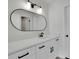 Bathroom with white vanity, black hardware, oval mirror and modern lighting at 683 Highland Ct, Marietta, GA 30068