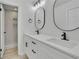 Bathroom featuring double sinks, modern fixtures, white cabinets, and a shower at 683 Highland Ct, Marietta, GA 30068