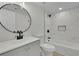 Modern bathroom with white marble shower tile, round mirror, and updated fixtures at 683 Highland Ct, Marietta, GA 30068