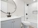 Modern bathroom with stylish vanity, round mirror, and tiled shower-tub combination with niche at 683 Highland Ct, Marietta, GA 30068